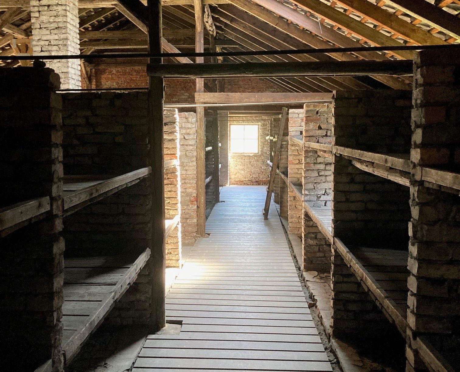 A barracks for prisoners at Auschwitz.  Each level of these crude beds would have slept six or seven prisoners.