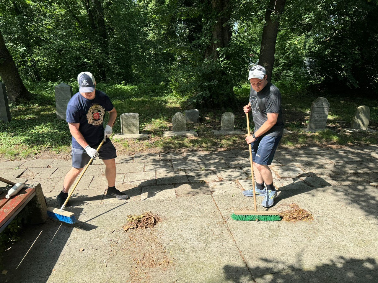 Midshipmen Andrew Johnson and Austin Locke cleaning the Jewish Cemetery in the town of Oswiecim (Auschwitz)