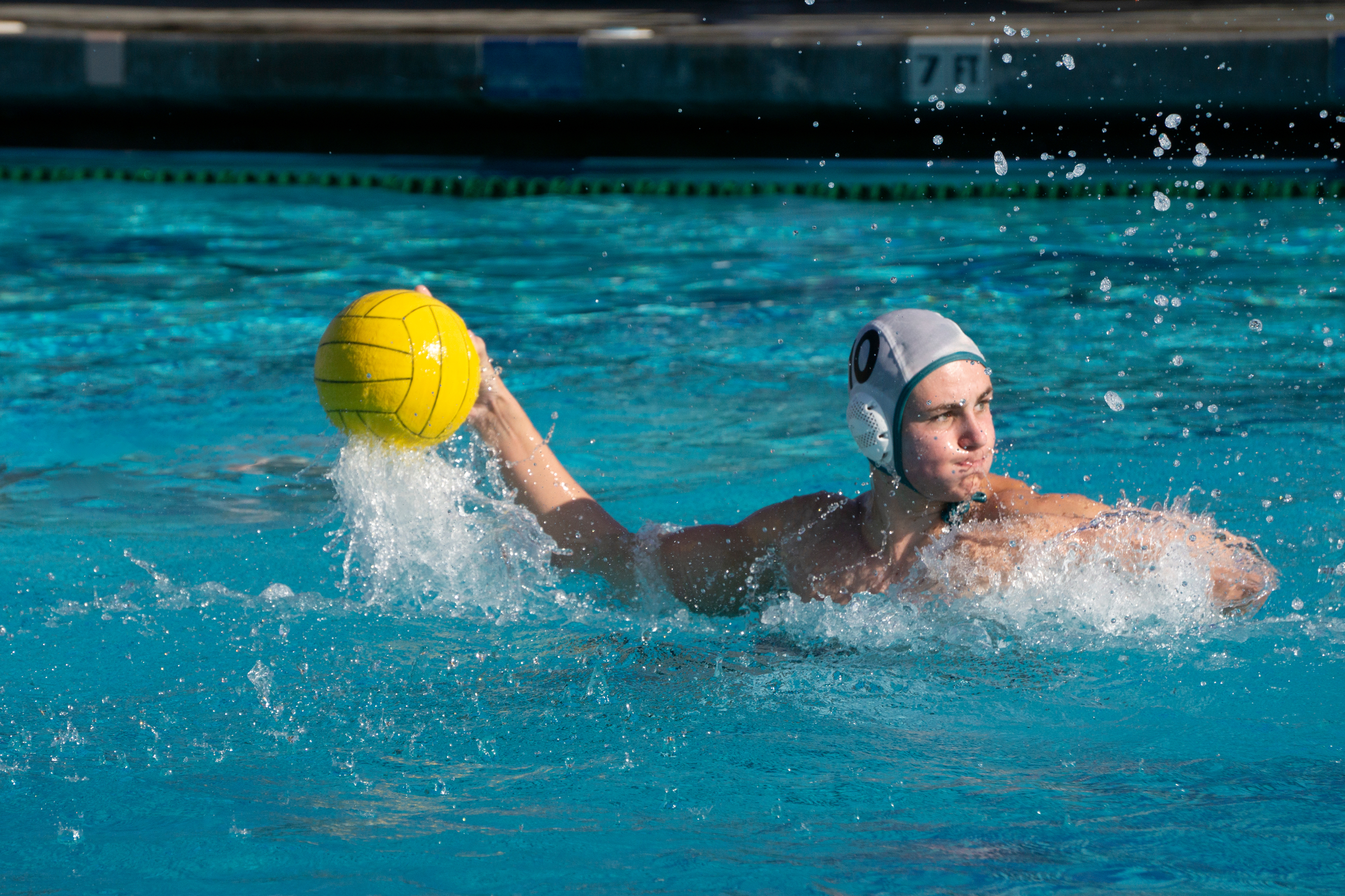 Water polo player shooting the ball.