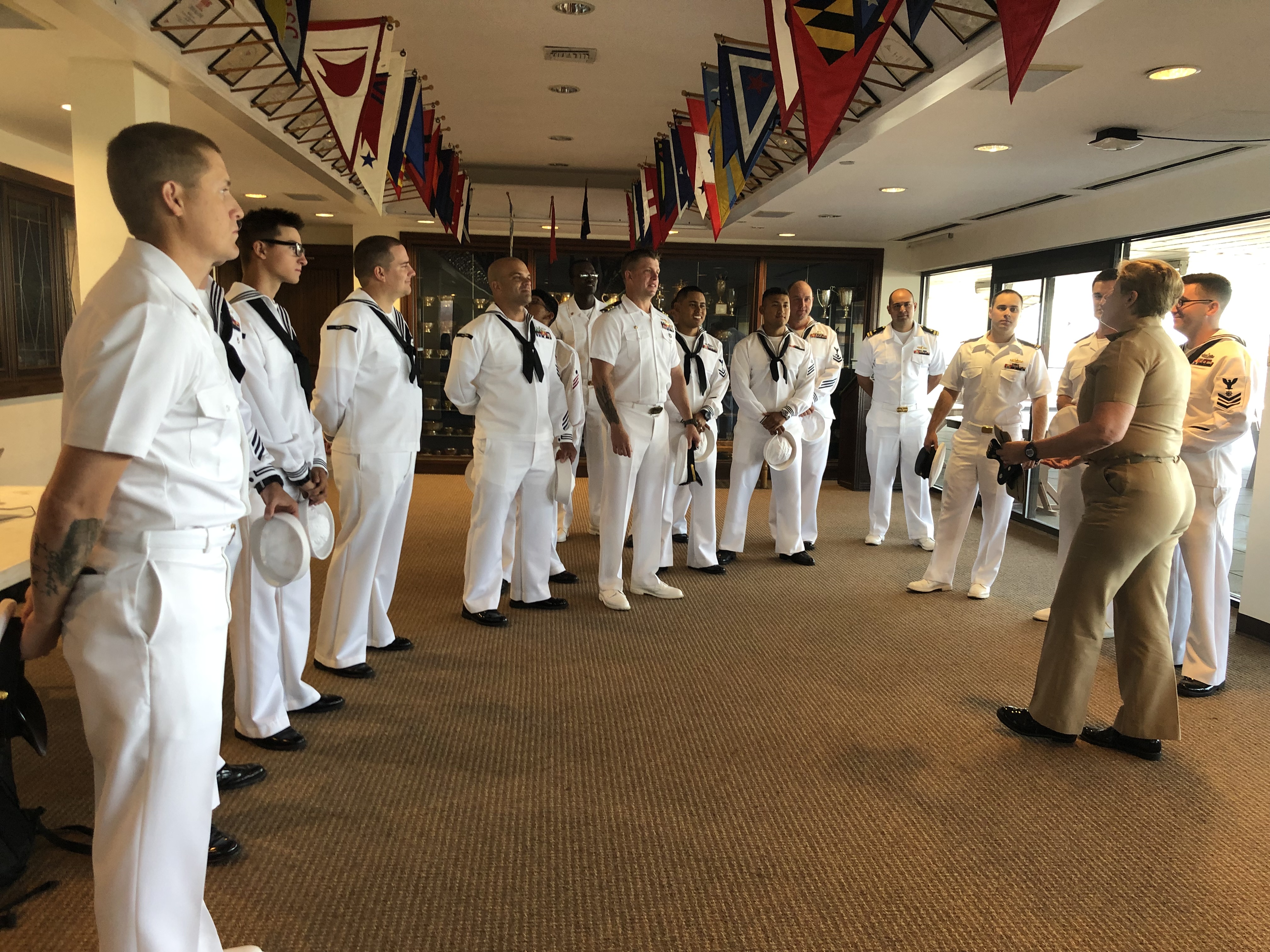 RDML Dunlap welcomes Girl Scouts and proudly shows her merit badges