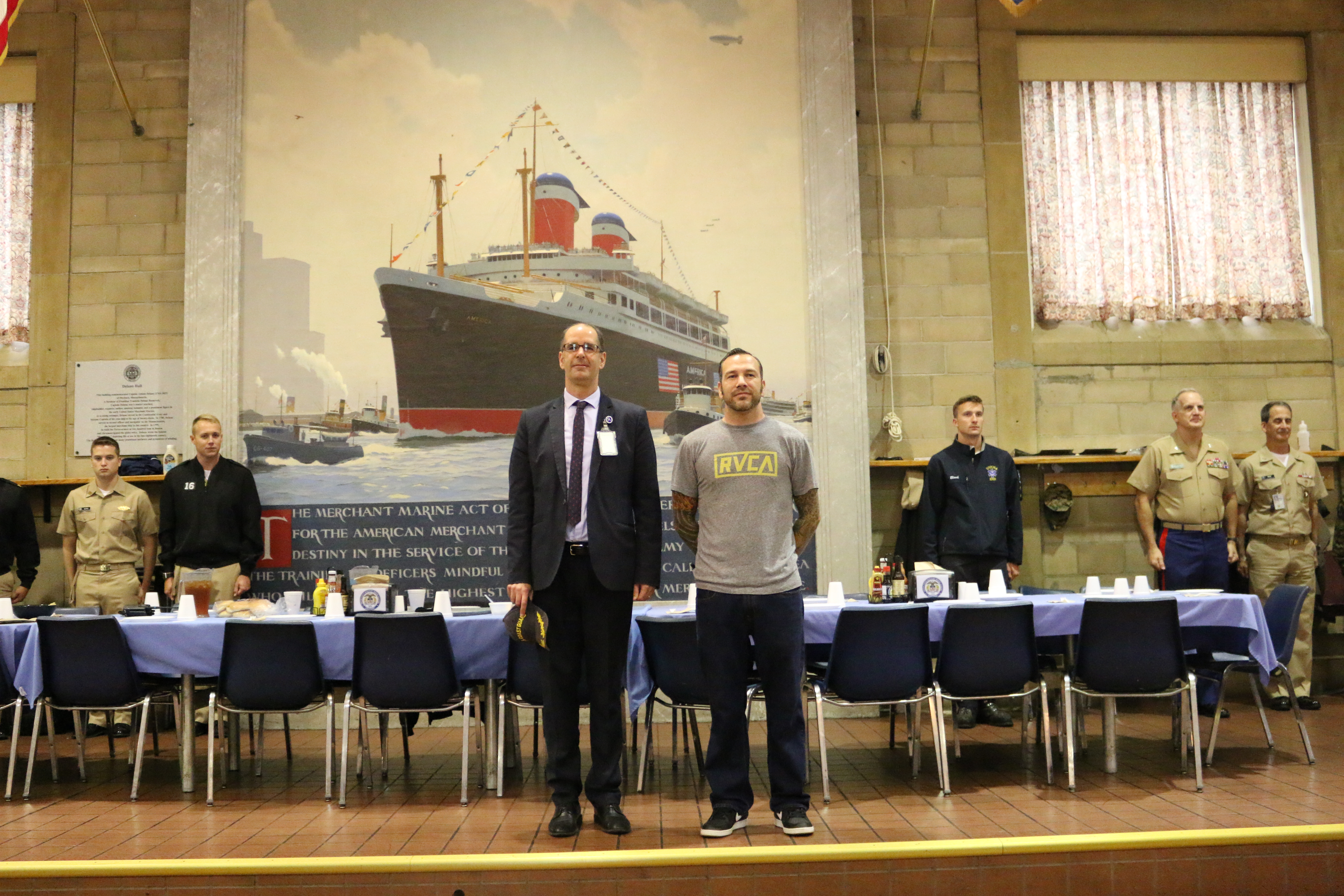 Coast Guard Veterans, Benjamin Benson and Professor John Jaeger at attention during "Semper Paratus"