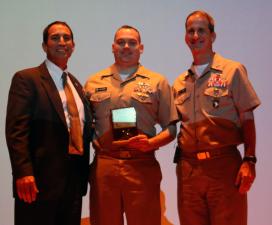 Deputy Maritime Administrator Mike Rodriguez ’79, and USMMA Superintendent Rear Adm. James A. Helis, USMS, present Lt. Cmdr. Pau