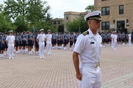 Regimental Commander, Midshipman Liam Pickett, 1/C, presents plebe candidates to VADM Buono