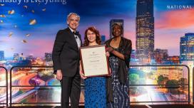 Dr.  Ping Furlan accepts award