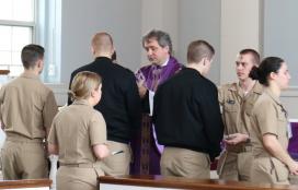 Father Mirek Lesiecki, CP, distributes ashes during Ash Wednesday Mass.