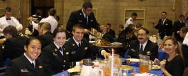 CAPT Moskoff and Daphne Fotiades enjoy a holiday meal with midshipmen