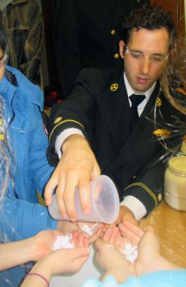 Midshipman 1st Class Timothy Parker gives a “hands-on” science demonstration.