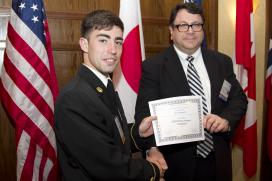 Midshipman Ian Holtzworth receives award from Captain Joseph Gross. Photo Credit: Chris Preovolos 