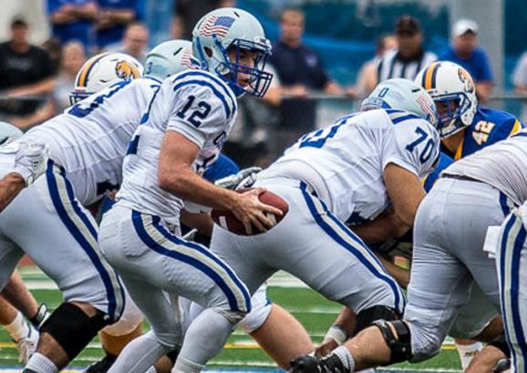The USMMA team playing football.